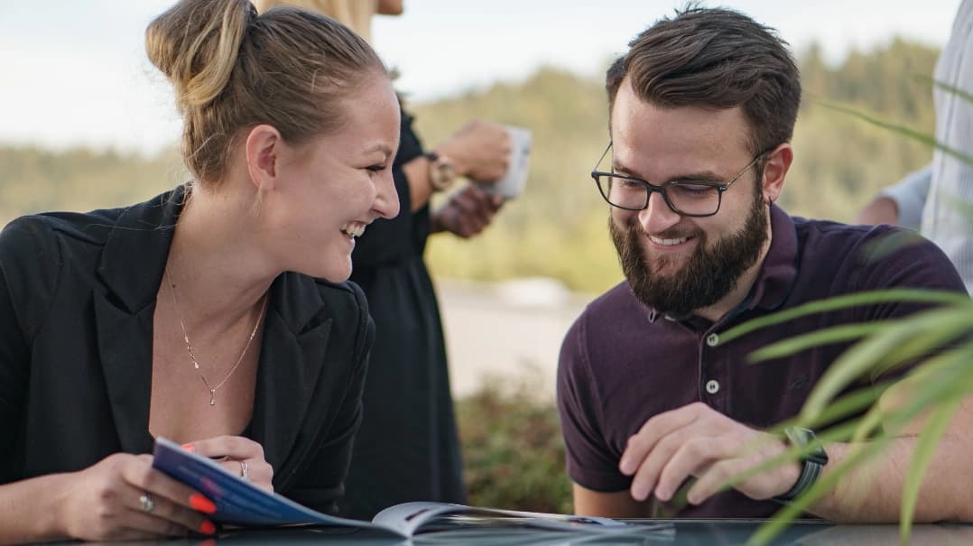 MRS colleagues sitting outdoors, reading and enjoying the MRS Newsletter | MRS Technologies International